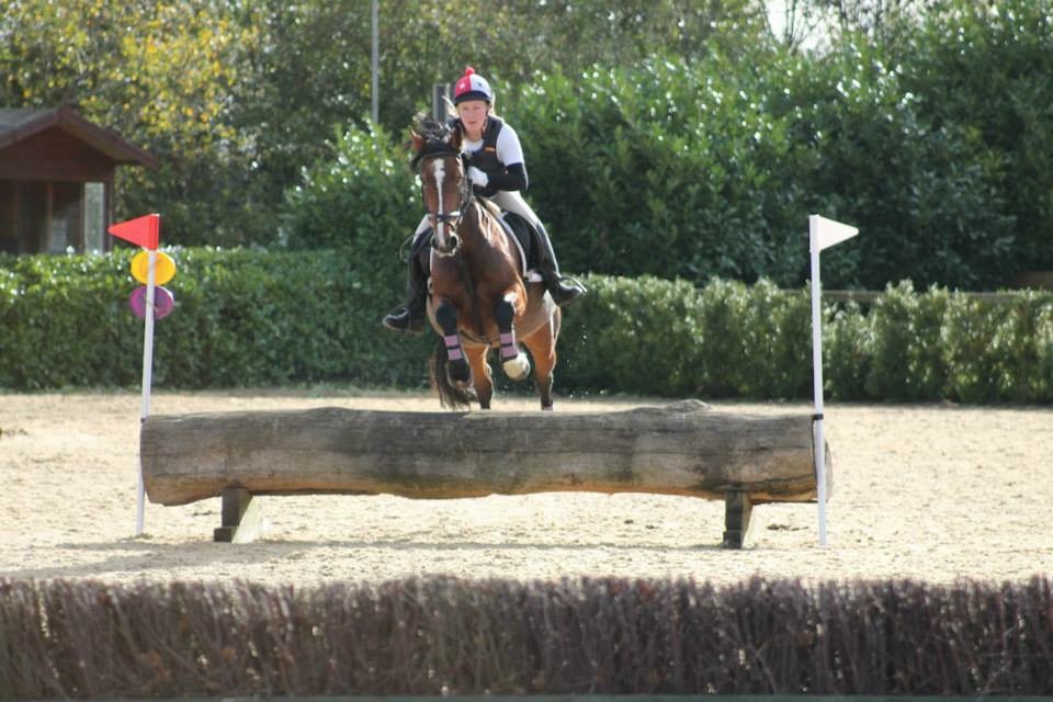 Katie Taylor riding her horse jumping over a fence during an event