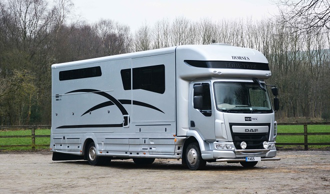 A horse lorry parked at a farm yard