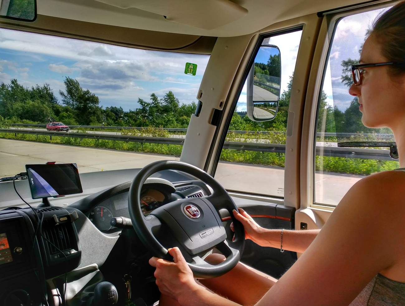 A woman driving a horsebox on a dual carriage way