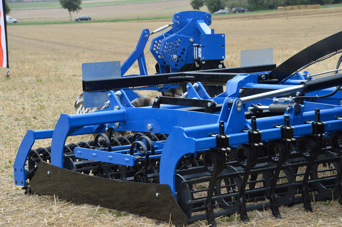 A harrow being used on a field